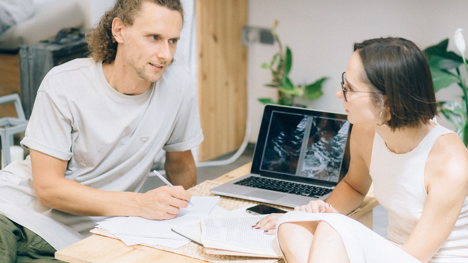 Two people discussing plans at a table